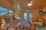 Upstairs master bedroom with King bed, flat screen tv and private screen porch 